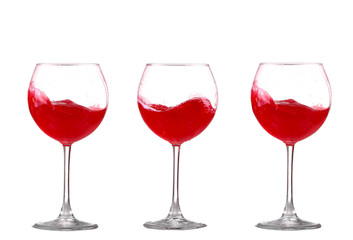 red wine splashing in a glass, isolated on white