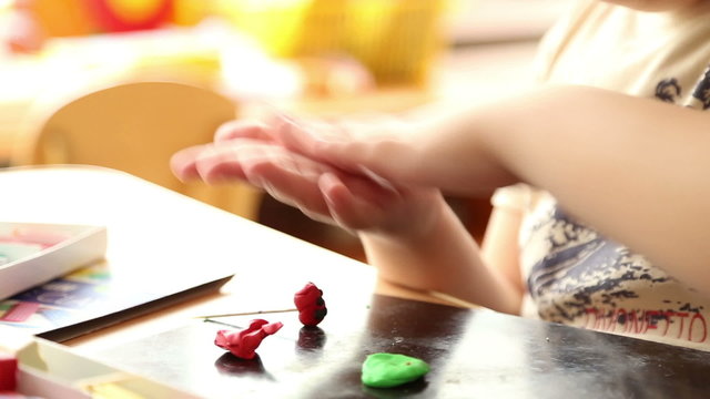 Young children are sculpting figures of plasticine
