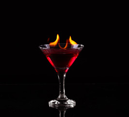 Flaming cocktail over black