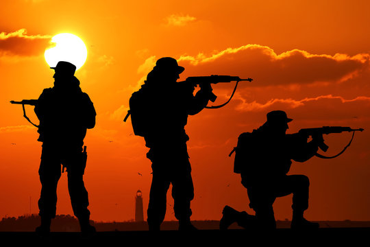 silhouette of Soldiers team with sunrise background