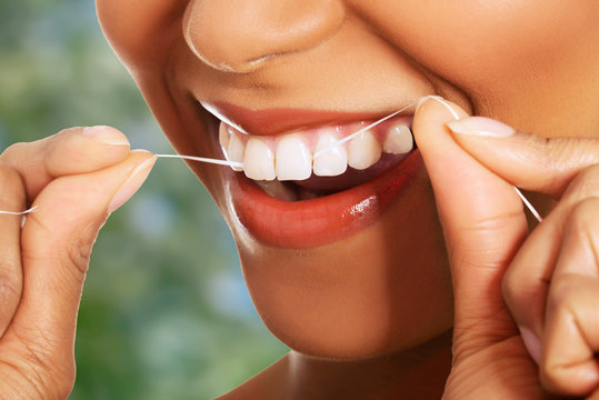 Woman Flossing Teeth.