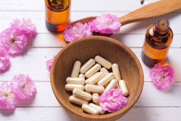 Fototapeta na wymiar Pills and flowers. Concept homeopathy.