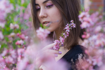 Fototapeta premium portrait of young beautiful girl in flowers