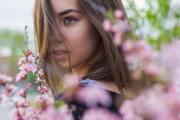 portrait of young beautiful girl in flowers