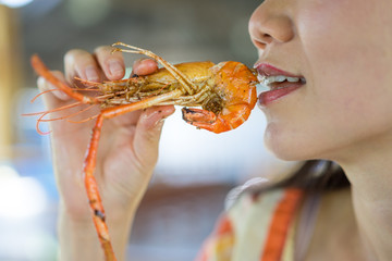woman eating a shrimp