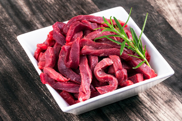 Fresh uncocked Beef sliced meat, rosemary