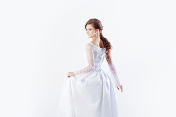 Fototapeta na wymiar Portrait of happy bride in wedding dress, white background
