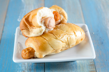 Bread with Sausage in dish on wooden