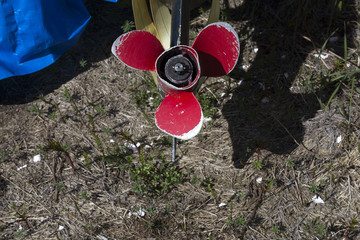 A propeller on a boat engine above the water. 