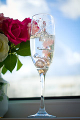 wedding rings in a glass with champagne