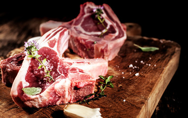 Raw Seasoned Lamb Filets on Rustic Wooden Board