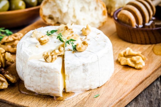 Camembert cheese with walnuts,  honey and thyme closeup