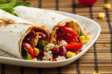 Traditional Mexican food, burritos with meat and beans, selectiv