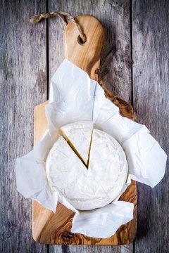 Whole Camembert cheese and portion