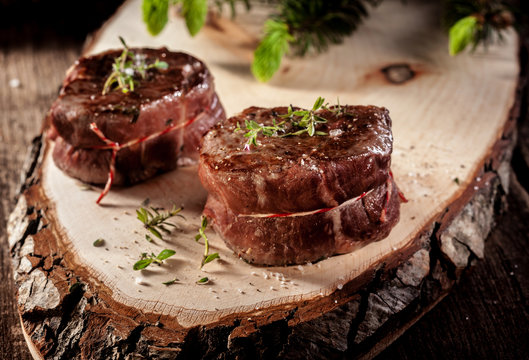 Venison Steak Filets Served on Rustic Wood Plank