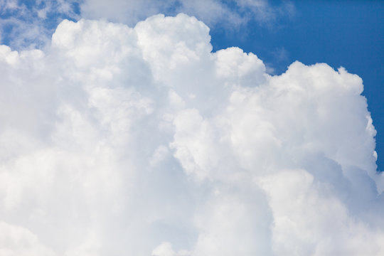 close up of white fluffy cumulus cloud in the blue sky