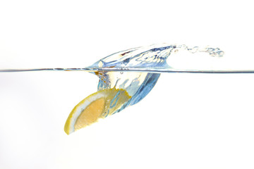 Lemon falling into water with a splash