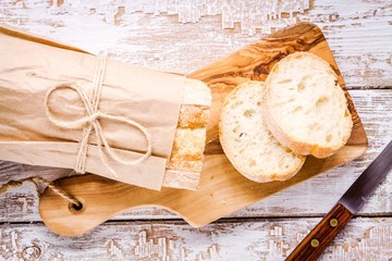 French Baguette sliced on cutting board