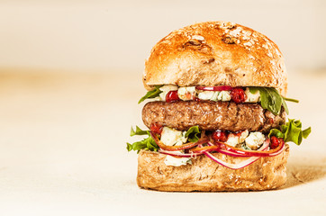 Hamburger Piled with Fresh Toppings on Wheat Roll