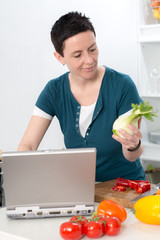 woman with short dark hair looking for cooking recipe in the int