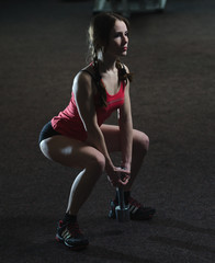 Fototapeta na wymiar Young athletic girl in the gym