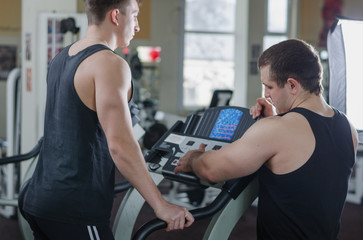 Fototapeta na wymiar Coach and athlete on a treadmill