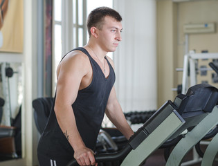 Naklejka na ściany i meble Athlete on the treadmill