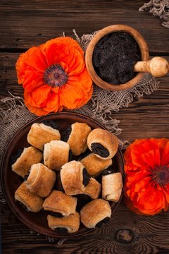 Rolls with poppy seeds on a wooden table. rustic style