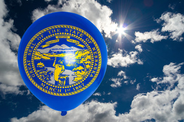 balloon with flag of nebraska on sky