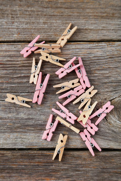 Wood clothespins on grey wooden background
