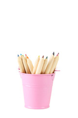 Pink bucket with pencils isolated on white