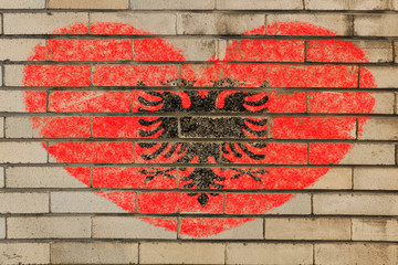 heart shape flag of albania on brick wall