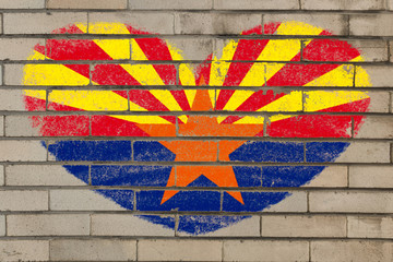 heart shape flag of arizona on brick wall