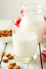 Glass of milk on white wooden background