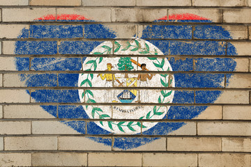 heart shape flag of belize on brick wall