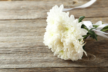 White chrysanthemum flowers on grey wooden background