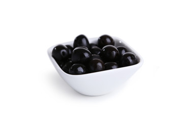 Black olives in bowl isolated on white
