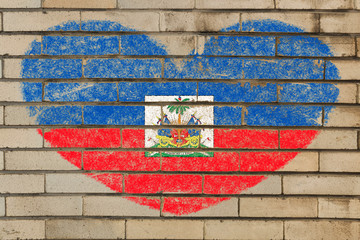 heart shape flag of Haiti on brick wall