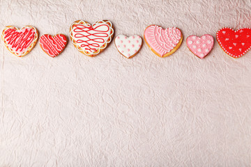 Fototapeta na wymiar Heart cookies on pink paper background