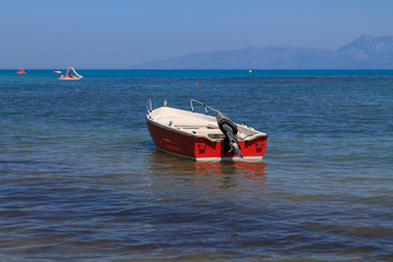 Fototapeta na wymiar Boat in the beautiful blue water off the Corfu coast