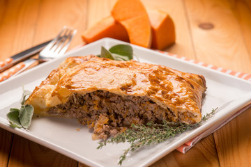 strudel stuffed with chopped meat pumpkin and herbs, selective focus