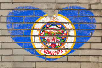 heart shape flag of minnesota on brick wall