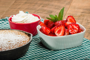 Cast iron skillet with cake and berries