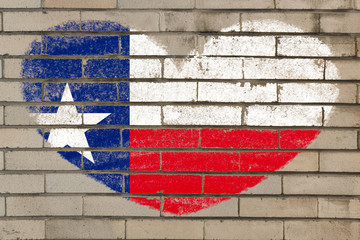 heart shape flag of texas on brick wall