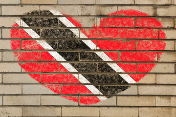 heart shape flag of trinidad and tobago on brick wall