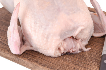 Raw chicken carcass on cutting board isolated on white