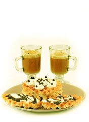 Plate with waffles and cups with cappuccino