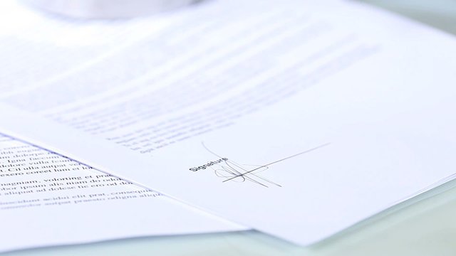 hand signing a document, signature concept