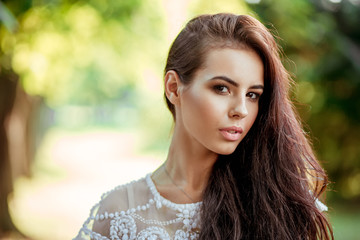 Fototapeta premium beautiful girl in a white dress on nature