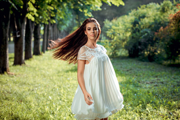 Fototapeta na wymiar beautiful girl in a white dress on nature